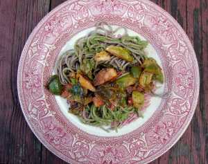 Soba noodles with arugula-pecan pesto and sauteed brussels sprouts
