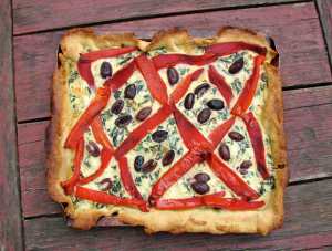 Ricotta tart with red peppers, chard and black olives
