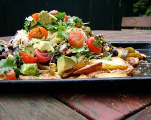 Thin crispy potatoes with black beans and guacamole