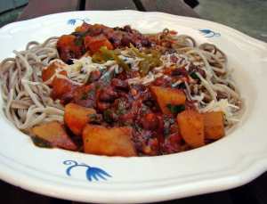 Soba noodles with roasted red pepper sauce, black beans, spinach and tomatoes.