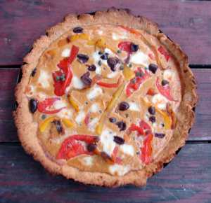 Roasted pepper tart with tomatoes, olives, and hazelnuts