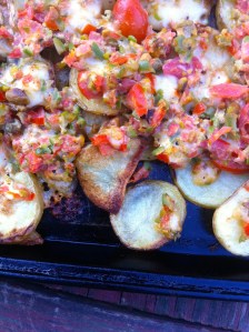 Thinly sliced potatoes with goat cheese, olives and tomatoes